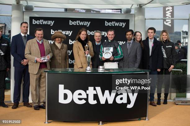 Camilla, Duchess of Cornwall Honorary Member of the Jockey Club, makes a presentation to the winners of The Betway Queen Mother Champion Steeple...