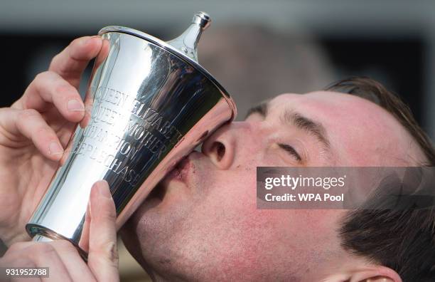 Winning Jockey Nico De Boinville on "Altior" kisses the trophy after winning the Betway Queen Mother Champion Steeple Chase on the second day of The...