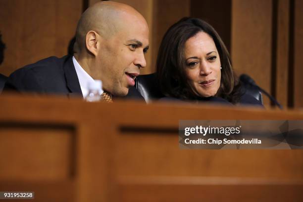 Senate Judiciary Committee members Sen. Cory Booker and Sen. Kamala Harris talk during a hearing about the massacre at Marjory Stoneman Douglas High...