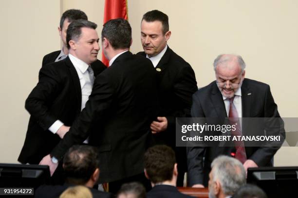 Nationalist politician and member of opposition party VMRO-DPMNE, Nikola Gruevski is pushed away from Parliament speaker Talat Xhaferi during a...