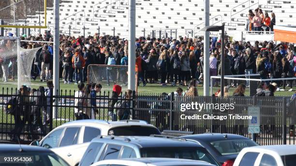 Approximately 300 students participate in a walkout to remember the victims of the Parkland, Fla. Shooting one month ago, at Naperville North High...