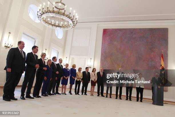 German Chancellor Angela Merkel poses with her new complete cabinet as she takes her oath from Germany President Frank-Walter Steinmeier, R, to serve...