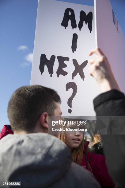 Student holds a sign reading "Am I Next?" outside the White House during the ENOUGH: National School Walkout rally in Washington, D.C., U.S., on...