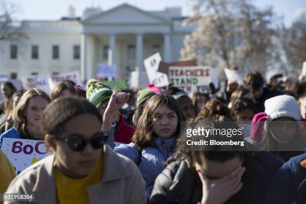 Students sit outside the White House during the ENOUGH: National School Walkout rally in Washington, D.C., U.S., on Wednesday, March 14, 2018....