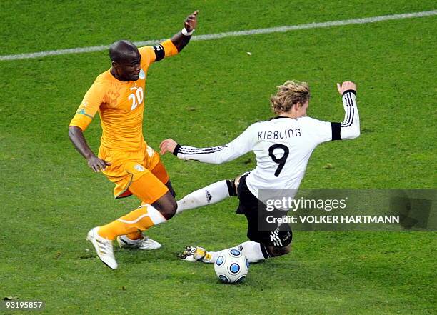 Cote d'Ivoire defender Guy Demel and German forward Stefan Kiessling vie for the ball during the friendly football match Germany vs Ivory Coast in...