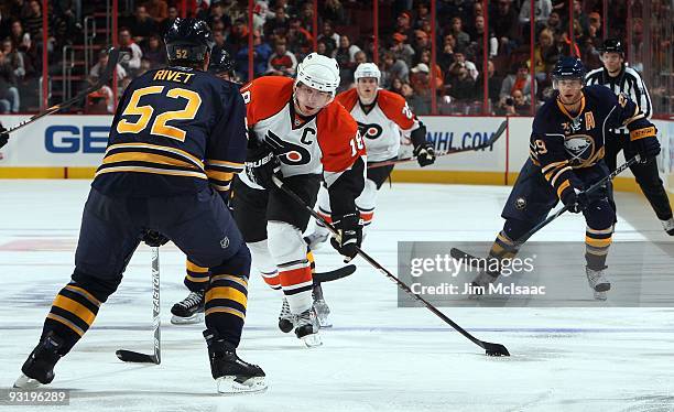 Mike Richards of the Philadelphia Flyers skates against Craig Rivet of the Buffalo Sabres on November 14, 2009 at Wachovia Center in Philadelphia,...