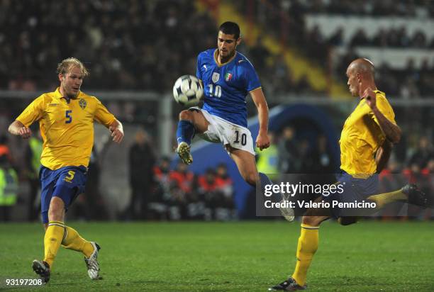 Antonio Candreva of Italy is challenged by Mikael Dorsin and Daniel Majstorovic of Sweden during the international friendly match between Italy and...