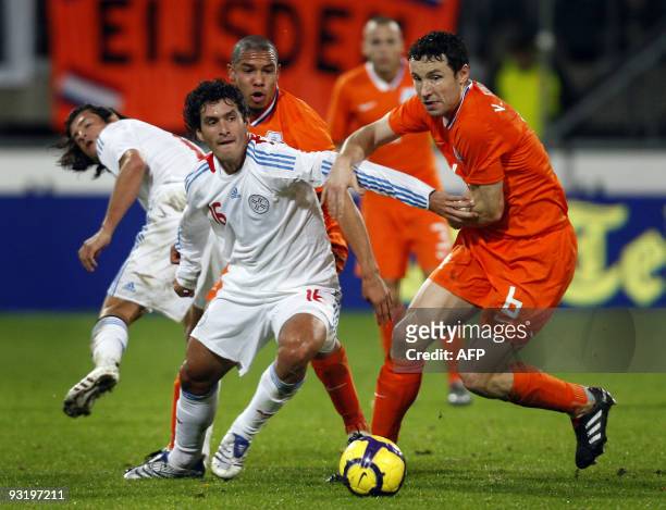 Dutch Mark van Bommel of Netherlands fights for the ball with Cristian Riveros Nunez of Paraguay during their friendly football match in Heerenveen,...