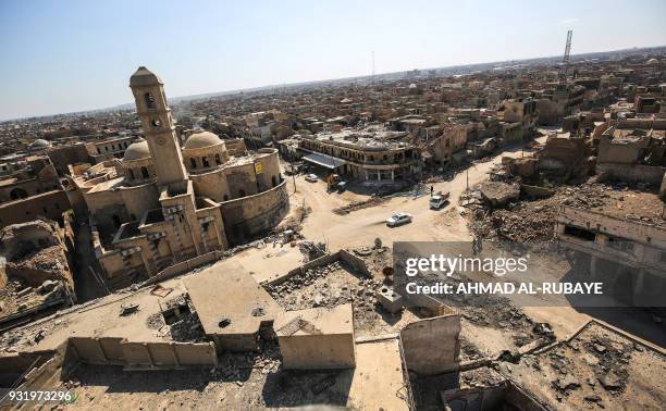 Picture taken on March 14, 2018 shows a view of destruction surrounding the Roman Catholic Church of Our Lady of the Hour in the old city of Mosul,...