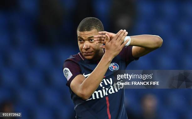 Paris Saint-Germain's French forward Kylian MBappe reacts at the end of the French Ligue 1 football match between Paris Saint-Germain and Angers at...