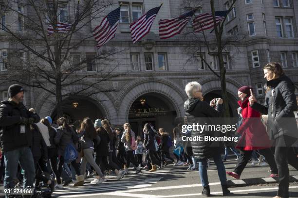 Students march past the Trump International Hotel during the ENOUGH: National School Walkout rally in Washington, D.C., U.S., on Wednesday, March 14,...