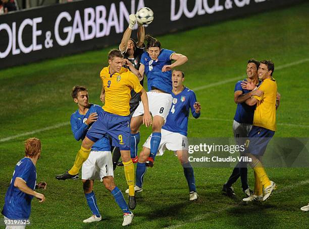 Goalkeeper Federico Marchetti of Italy punches the ball away beside Riccardo Montolivo of Italy and Viktor Elm of Sweden during the international...