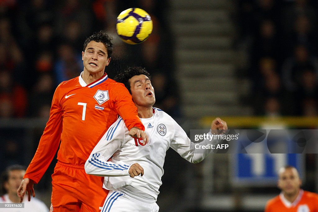 Dutch Ibrahim Afellay (L) vies for the b