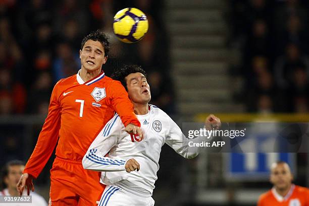 Dutch Ibrahim Afellay vies for the ball with Cristian Riveros Nunez of Paraguay during their friendly football match in Heerenveen, on November 18,...