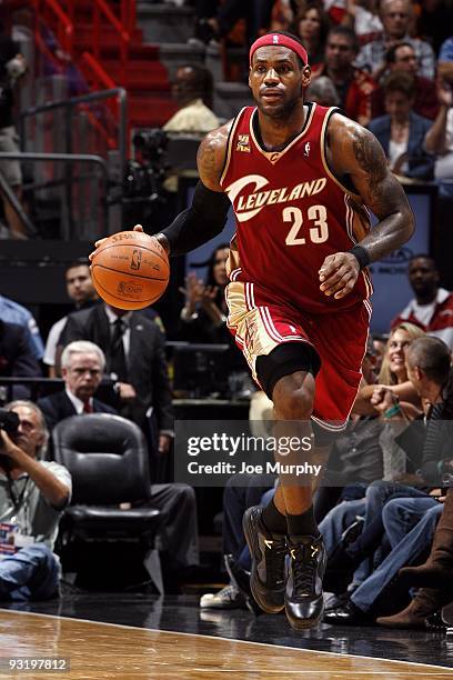 LeBron James of the Cleveland Cavaliers moves the ball up court during the game against the Miami Heat at American Airlines Arena on November 12,...