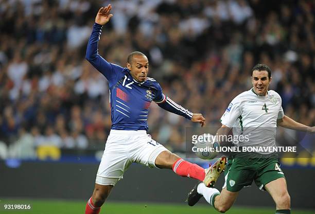 French forward Thierry Henry controls the ball in front of Irish defender John O'Shea during the World Cup 2010 qualifying football match France vs....