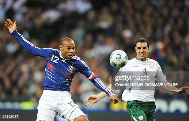 French forward Thierry Henry controls the ball in front of Irish defender John O'Shea during the World Cup 2010 qualifying football match France vs....