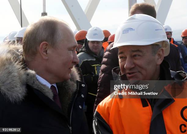 Russian President Vladimir Putin and Russian billionaire and businessman Arkady Rotenberg visit the construction site for the Crimean bridge which is...