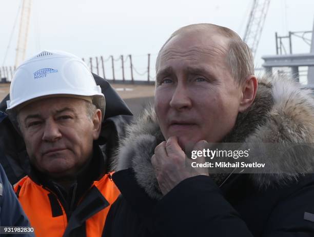 Russian President Vladimir Putin and Russian billionaire and businessman Arkady Rotenberg visit the construction site for the Crimean bridge which is...