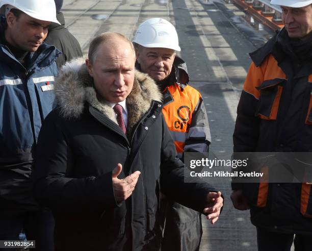 Russian President Vladimir Putin and Russian billionaire and businessman Arkady Rotenberg visit the construction site for the Crimean bridge which is...