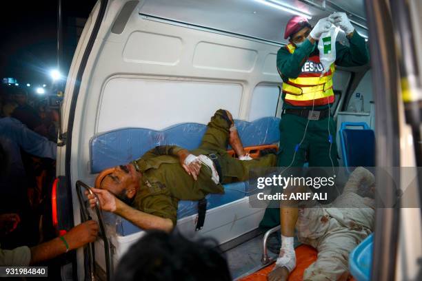 Pakistani rescue worker gives medical treatment to injured blast victims in an ambulance following a motorcycle bomb attack in Lahore on March 14,...