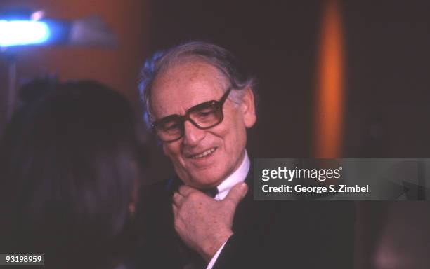 French fashion designer Pierre Cardin smiles as he speaks to an unidentified person, late 1980s or early 1990s.