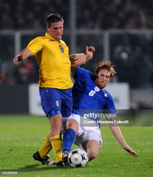 Davide Biondini of Italy tackles Anders Svensson of Sweden during the International Friendly Match between Italy and Sweden at Dino Manuzzi Stadium...