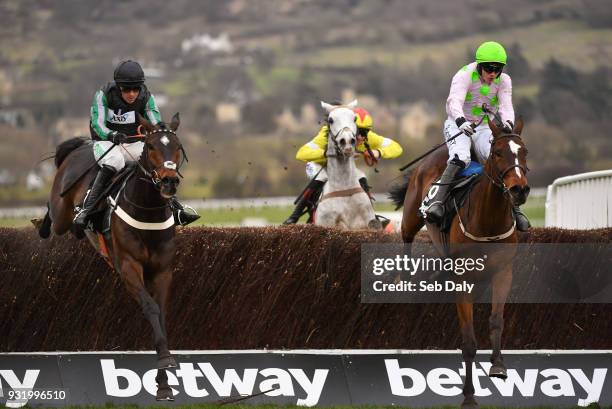Cheltenham , United Kingdom - 14 March 2018; Altior, left, with Nico de Boinville up, jumps the last, alongside Min, with Paul Townend up, on their...