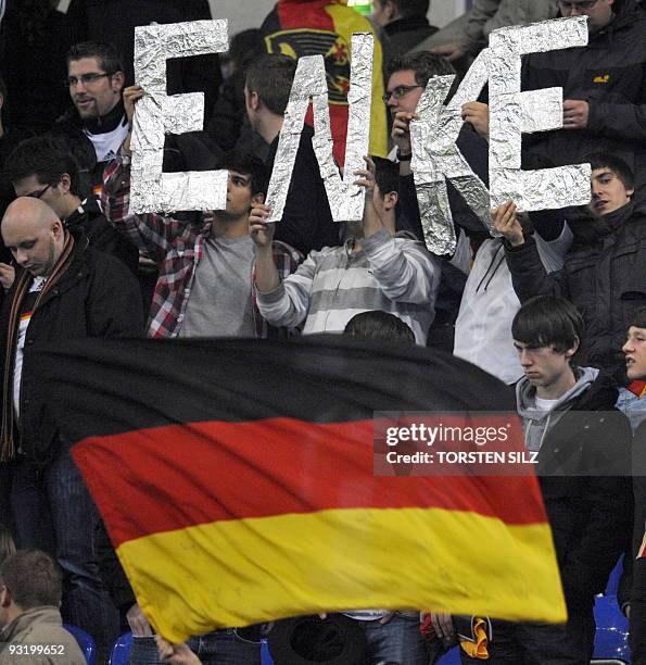 Fans hold up the name of deceased German national goalkeeper Robert Enke during the friendly football match Germany vs Ivory Coast in Gelsenkirchen,...