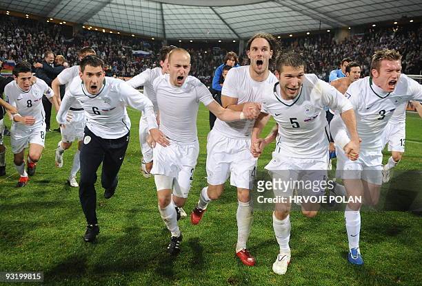 Slovenia's team celebrate after their World Cup 2010 qualifying play-off second leg football match between Slovenia and Russia, in Maribor, some 150...