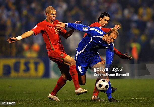 Zlatan Muslimovic of Bosnia-Herzegovina is challenged by Pepe and Tiago of Portugal during the FIFA 2010 World Cup Qualifier 2nd Leg match between...