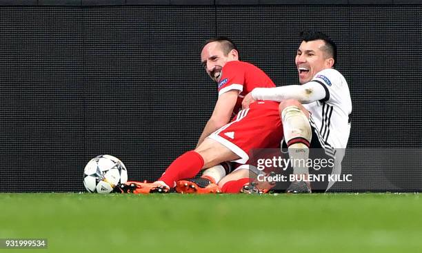 Bayern Munich's French midfielder Franck Ribery shares a light moment after a tackle with Besiktas midfielder Gary Medel during the second leg of the...