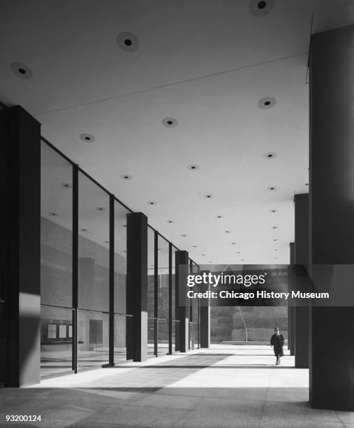 Exterior view of Dirksen Federal Building of the Chicago Federal Center showing a pedestrian walking outside the building, Chicago, IL, ca.1960s....