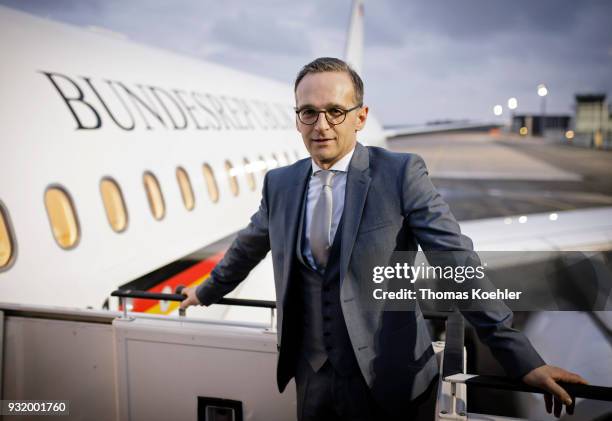 German Foreign Minister Heiko Maas poses for the photographer in front of the airplane which is going to bring him to Paris, on March 14, 2018 in...