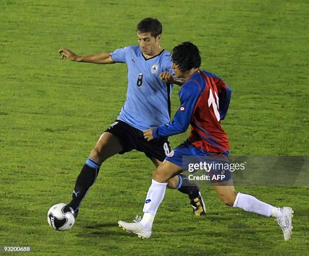 Uruguay's midfielder Sebastian Euguren vies for the ball with Costa Rica's midfielder Junior Diaz during their FIFA World Cup South Africa 2010...