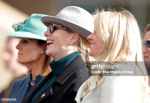 Natalie Pinkham, Zara Phillips and Chemmy Alcott watch the racing as they attend day 1 'Champion Day' of the Cheltenham Festival at Cheltenham...