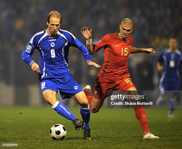 Zlatan Muslimovic of Bosnia-Herzegovina is challenged by Pepe of Portugal during the FIFA2010 World Cup Qualifier 2nd Leg match between...