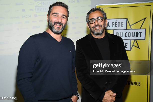 Olivier Nakache and Eric Toledano pose at "La Fete Du Cour Metrage" Photocall on March 14, 2018 in Paris, France.