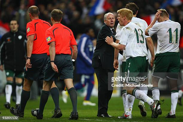 Liam Brady the assistant coach of Ireland restrains players including Paul McShane as they dispute with referee Martin Hansson during the FIFA 2010...
