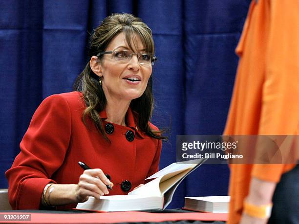 Former Republican vice presidential candidate and Alaska Governor Sarah Palin signs her new book, "Going Rogue" for a customer at a Barnes & Noble...