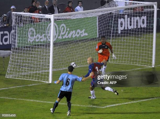 Uruguay's defender Andres Scotti tries to head the ball in front of Costa Rica's defender Luis Marin and Costa Rica's goalie Keilor Navas during...