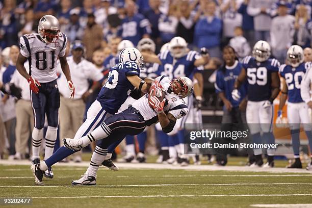 New England Patriots Kevin Faulk in action, stopped short on 4th down during tackle by Indianapolis Colts Melvin Bullitt to end game. Indianapolis,...