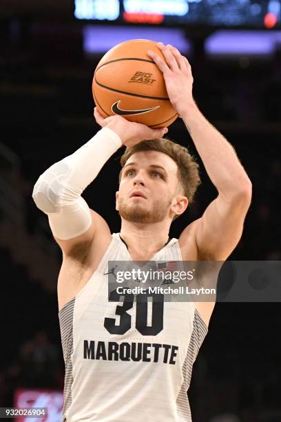 Andrew Rowsey of the Marquette Golden Eagles takes a foul shot during the 1st round of the Big East Basketball Tournament against the DePaul Blue...