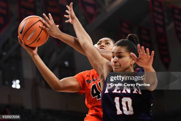 Leslie Robinson of the Princeton Tigers drives to the basket against Anna Ross of the Pennsylvania Quakers during the first quarter at The Palestra...