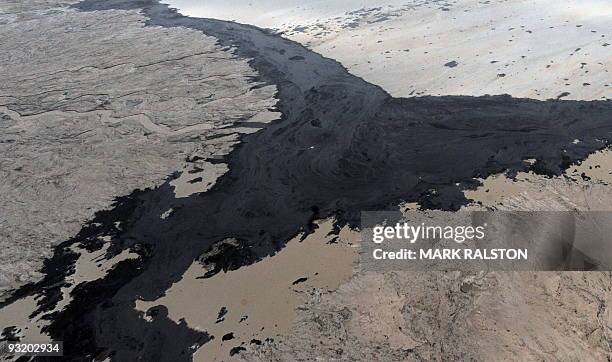 An aerial view of a tailings pond at the Suncor oil sands mine near the town of Fort McMurray in Alberta Province, Canada on October 23, 2009....