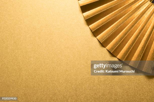 gold folding fan and copy space - waaier stockfoto's en -beelden