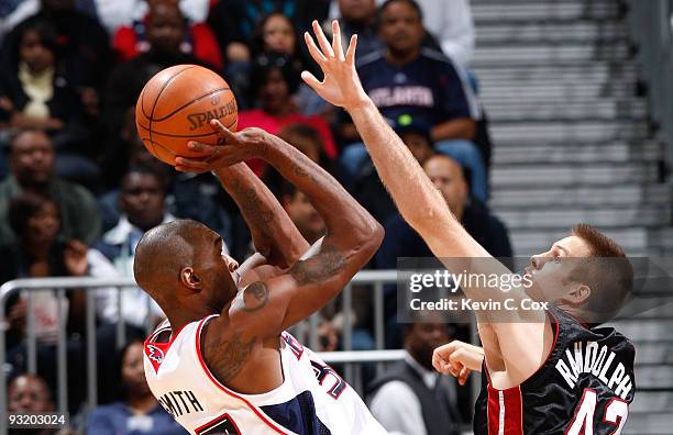 Joe Smith of the Atlanta Hawks shoots against Shavlik Randolph of the Miami Heat at Philips Arena on November 18, 2009 in Atlanta, Georgia.