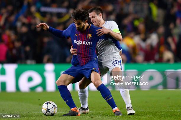 Chelsea's Spanish defender Cesar Azpilicueta challenges Barcelona's Portuguese midfielder Andre Gomes during the UEFA Champions League round of...