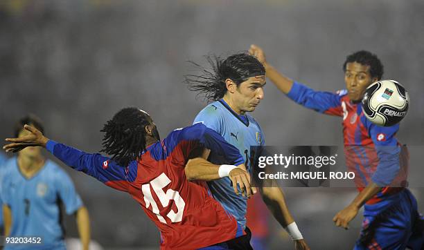 Uruguay's Sebastian Abreu heads the ball next to Costa Rican Junior Diaz during their FIFA World Cup South Africa 2010 qualifier football match at...