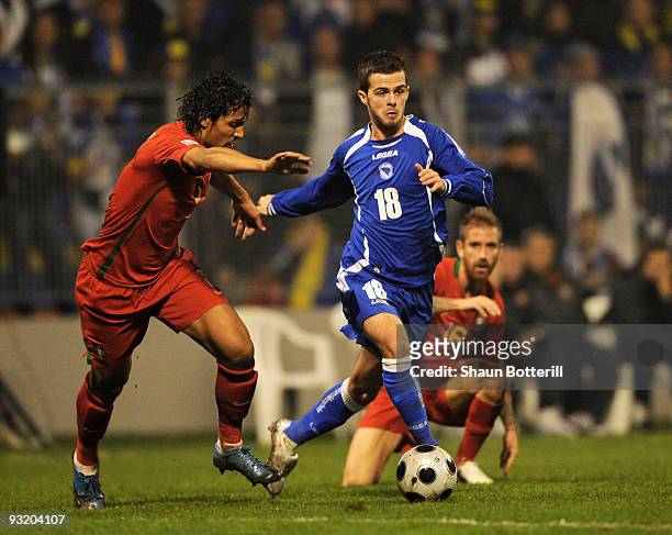 Miralem Pjanic of Bosnia-Herzegovina is challenged by Bruno Alves of Portugal during the FIFA2010 World Cup Qualifier 2nd Leg match between...